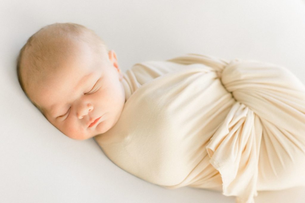 Newborn photos in swaddle by haven hill studios, a photographer in rolla, Missouri. 