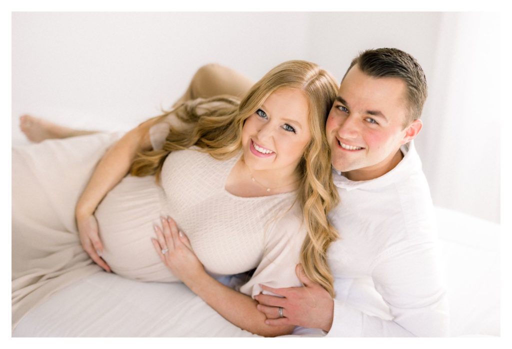 Maternity photos laying on bed by Rolla Photographer Haven Hill Studios. 