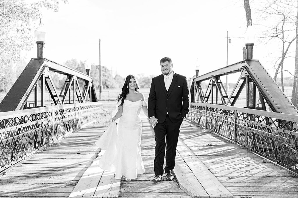 Romantic bride and groom portraits at Red Oak Valley in Owensville Missouri  on bridge
