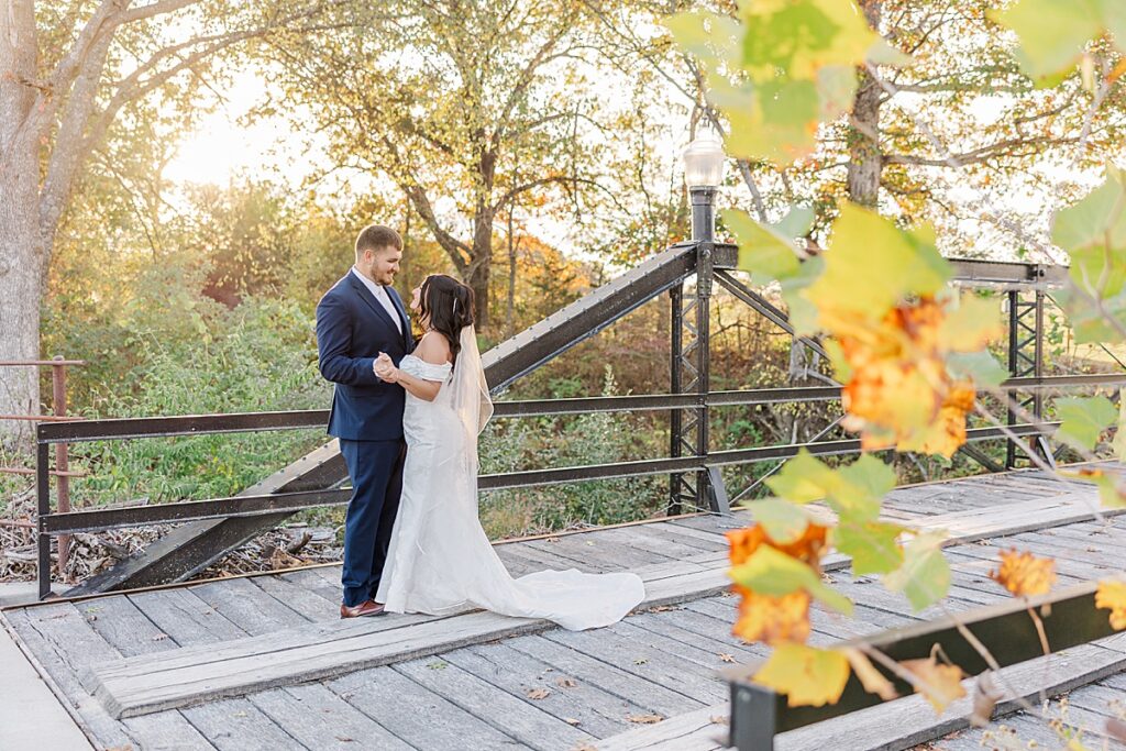 Romantic bride and groom portraits at Red Oak Valley in Owensville Missouri photo location on bridge

